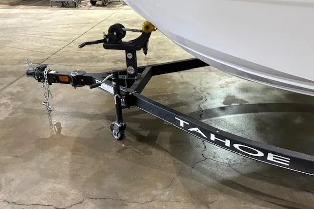 Slide: The Image of 2024 Tahoe T18 boat trailer with hitch and safety chains on concrete floor. - 41