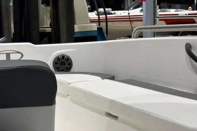 Slide: The Image of 2024 Tahoe T18 boat interior with white seating and speaker detail. - 7