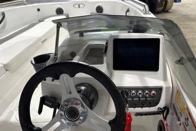Slide: The Image of 2024 Tahoe T18 boat dashboard with steering wheel and control panel. - 9