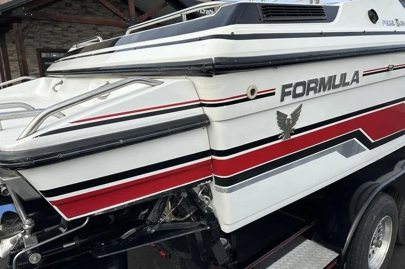 Slide: The Image of 1989 Formula 292 SR-1 boat with red, black, and white detailing on trailer. - 15