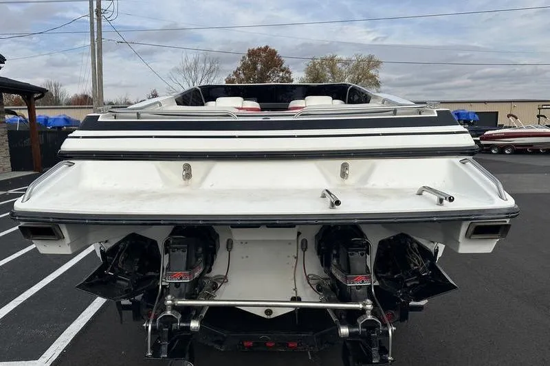 Slide: The Image of 1989 Formula 292 SR-1 boat rear view with dual engines in a parking lot. - 16