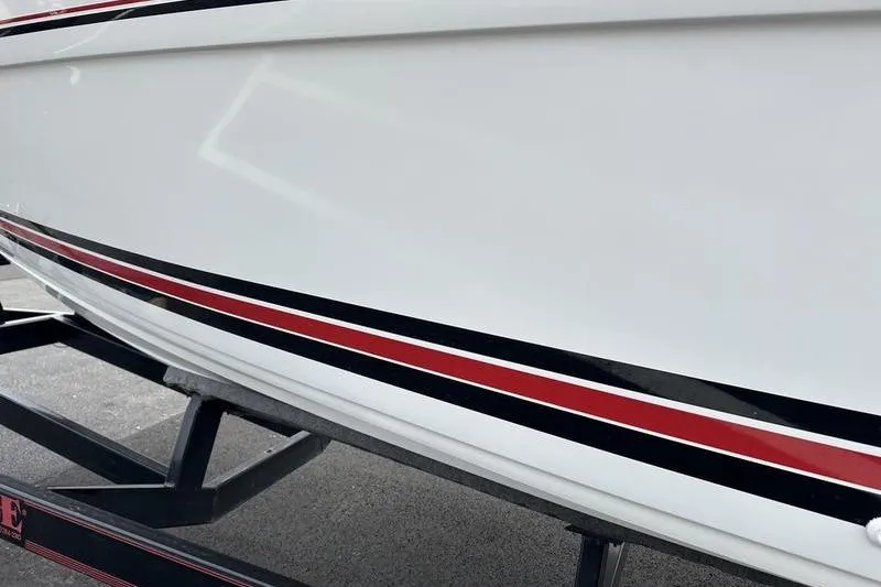 Slide: The Image of 1989 Formula 292 SR-1 boat with sleek white hull and red-black stripes on trailer. - 18