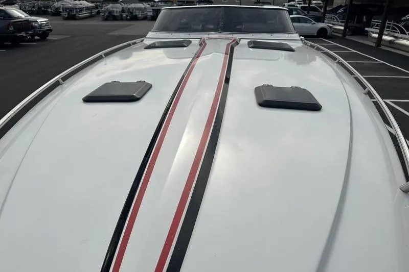 Slide: The Image of 1989 Formula 292 SR-1 boat with sleek red and black stripes on deck. - 20