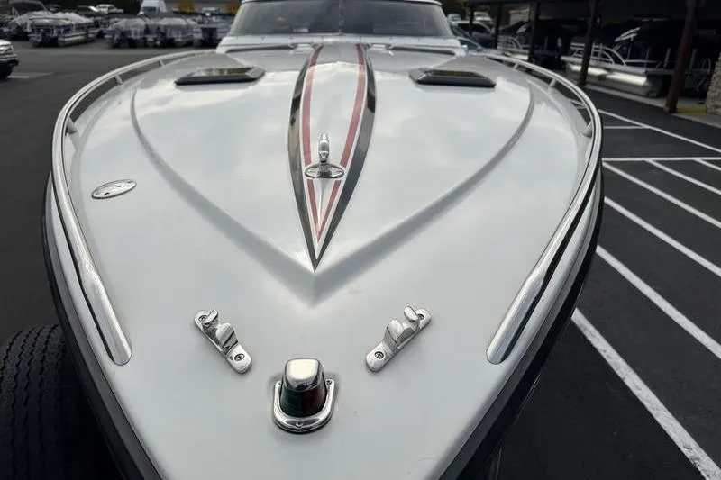 Slide: The Image of 1989 Formula 292 SR-1 boat, sleek design with red and black stripes, docked in marina. - 24