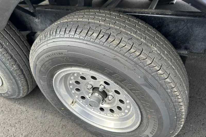 Slide: The Image of Close-up of a 1989 Formula 292 SR-1 trailer tire and wheel on asphalt. - 26