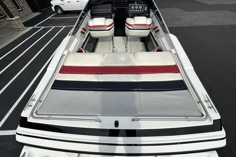 Slide: The Image of 1989 Formula 292 SR-1 boat with red, white, and black seating, docked on pavement. - 32