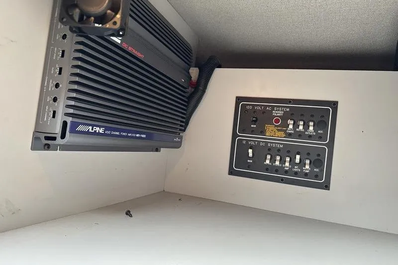 Slide: The Image of 1989 Formula 292 SR-1 electrical panel with Alpine amplifier and control switches. - 54