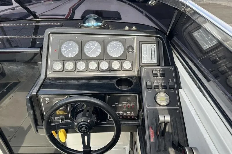 Slide: The Image of 1989 Formula 292 SR-1 boat dashboard with steering wheel and control gauges. - 57