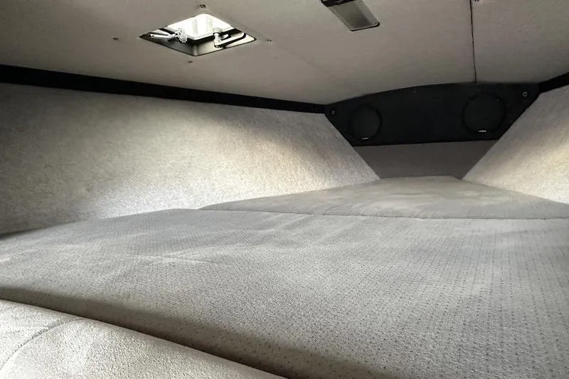 Slide: The Image of Interior cabin of a 1989 Formula 292 SR-1 boat, featuring a cushioned sleeping area. - 63