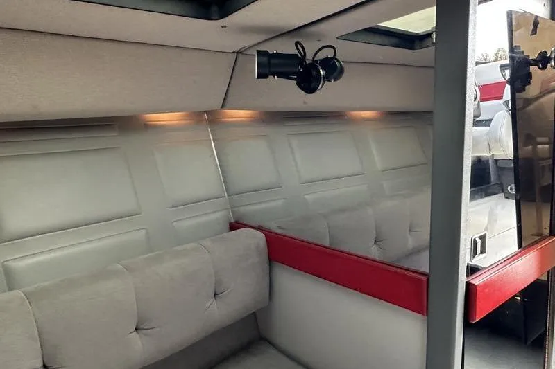 Slide: The Image of Interior of a 1989 Formula 292 SR-1 boat, featuring cushioned seating and modern lighting. - 64