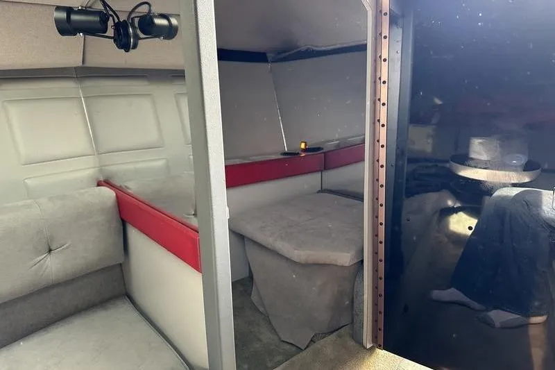 Slide: The Image of Interior of a 1989 Formula 292 SR-1 boat, featuring seating and a small table. - 66