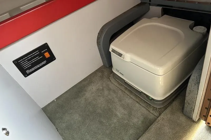 Slide: The Image of 1989 Formula 292 SR-1 boat interior with portable toilet on carpeted floor. - 76