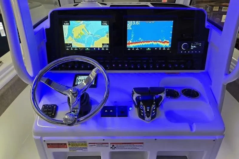 Slide: The Image of 2026 Sea Hunt Gamefish 25 dashboard with dual navigation screens and illuminated controls. - 13