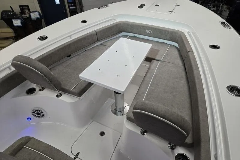 Slide: The Image of 2026 Sea Hunt Gamefish 25 boat interior with cushioned seating and table. - 17