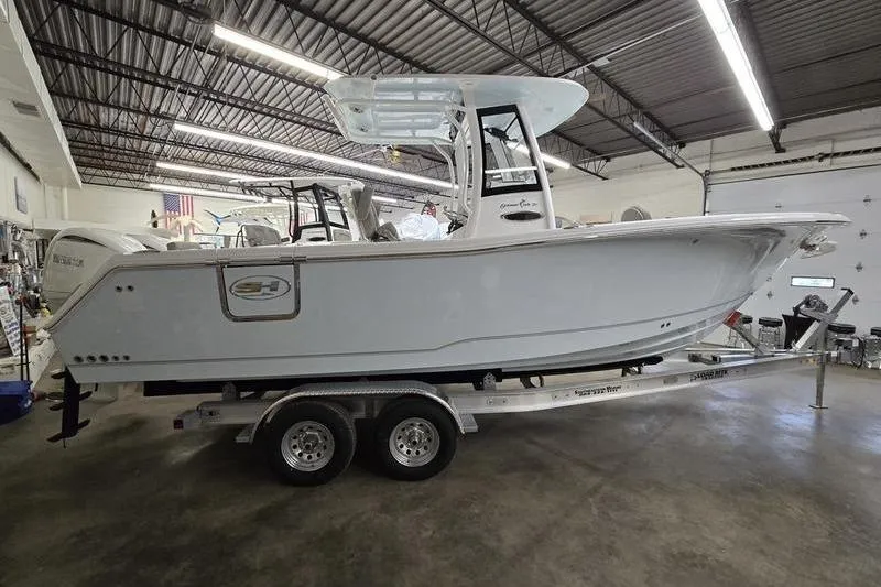 Slide: The Image of 2026 Sea Hunt Gamefish 25 boat on trailer in indoor storage facility. - 2