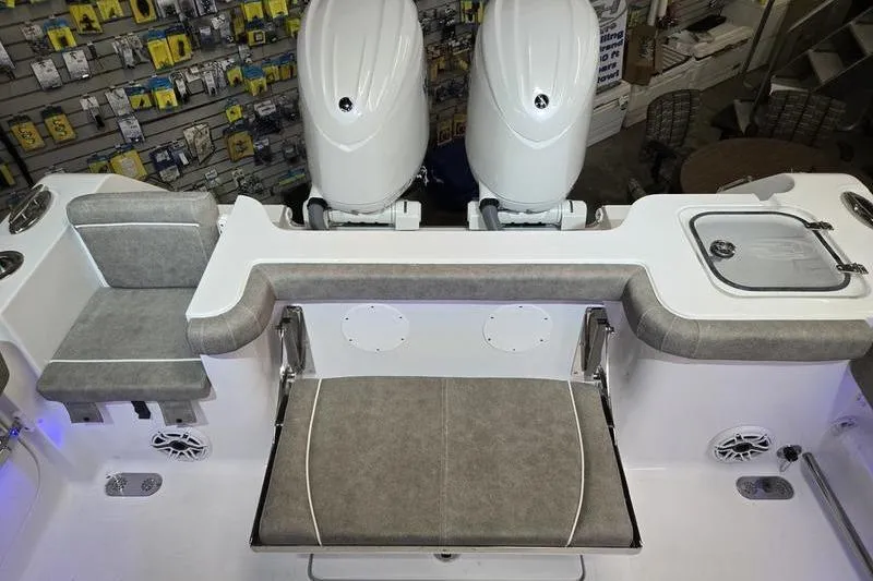 Slide: The Image of 2026 Sea Hunt Gamefish 25 boat interior with dual engines and seating area. - 20