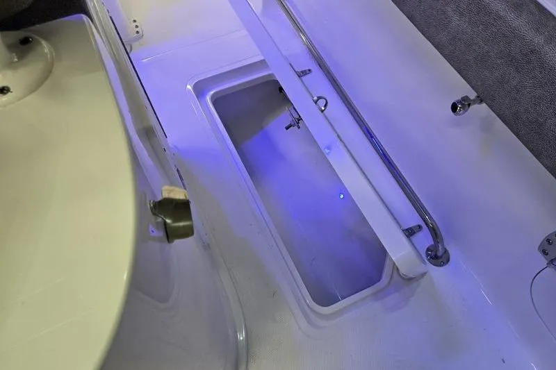 Slide: The Image of 2026 Sea Hunt Gamefish 25 boat interior with illuminated storage compartment. - 21