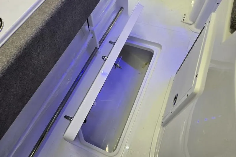 Slide: The Image of 2026 Sea Hunt Gamefish 25 boat storage compartment with blue LED lighting. - 23