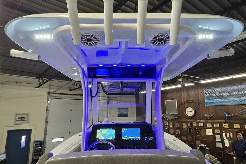 Slide: The Image of 2026 Sea Hunt Gamefish 25 boat console with blue LED lighting and advanced navigation displays. - 26