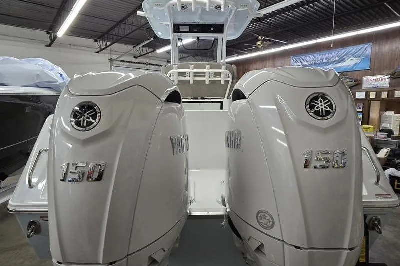 Slide: The Image of 2026 Sea Hunt Gamefish 25 with dual Yamaha 150 engines in a showroom. - 3