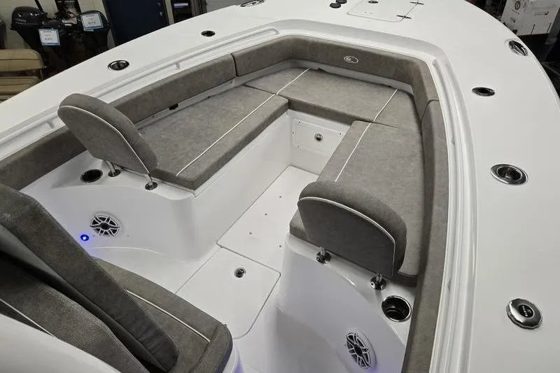 Slide: The Image of 2026 Sea Hunt Gamefish 25 boat interior with gray cushioned seating and white deck. - 5