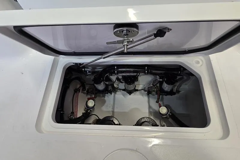 Slide: The Image of Open hatch of 2026 Sea Hunt Gamefish 25, showcasing internal components and wiring. - 7