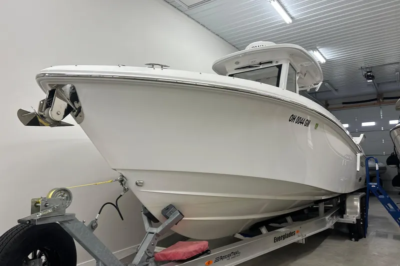 Slide: The Image of 2023 Everglades 285 Center Console boat on trailer in indoor storage. - 0