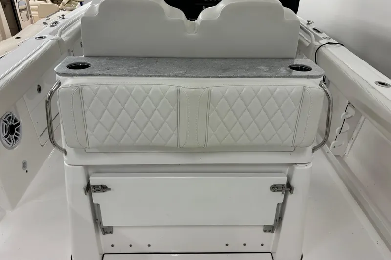 Slide: The Image of 2023 Everglades 285 Center Console boat interior with cushioned seating and storage. - 11