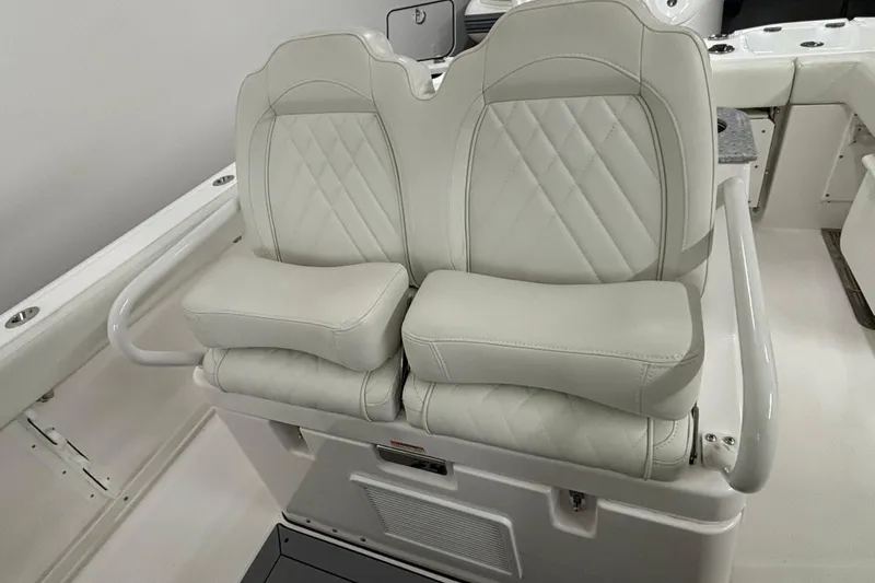 Slide: The Image of 2023 Everglades 285 Center Console boat with luxurious dual white seats. - 12
