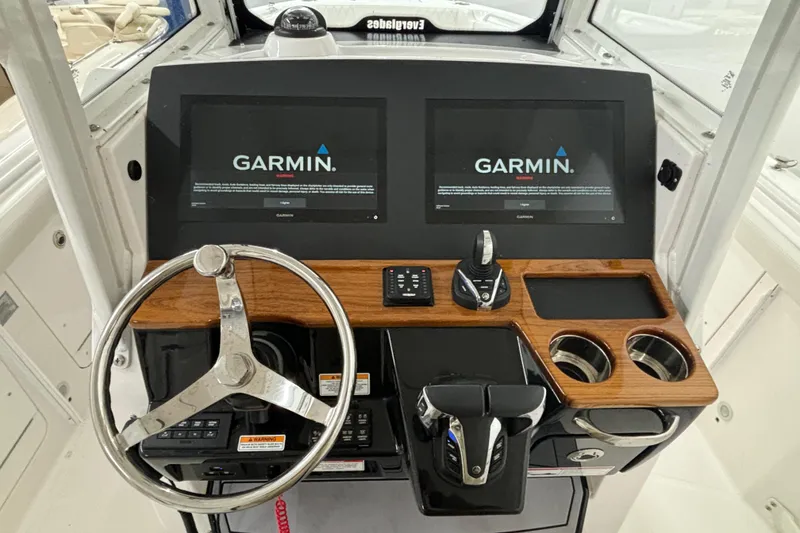 Slide: The Image of 2023 Everglades 285 Center Console helm with dual Garmin displays and modern controls. - 14