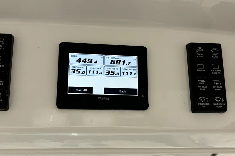 Slide: The Image of 2023 Everglades 285 Center Console dashboard with Yamaha display showing trip data and controls. - 16