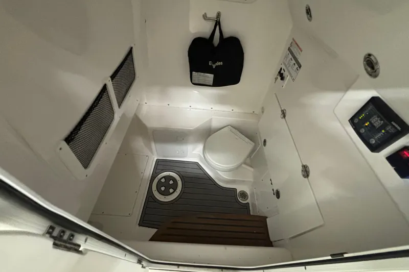 Slide: The Image of 2023 Everglades 285 Center Console boat interior with compact marine toilet. - 21