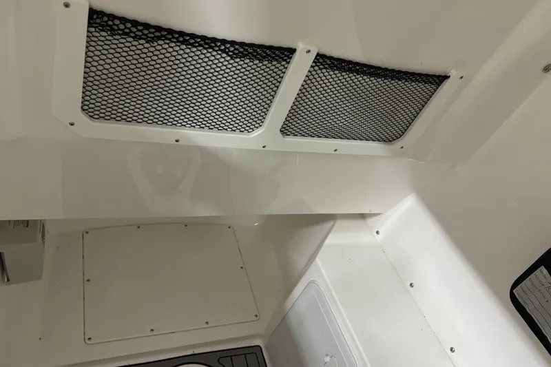 Slide: The Image of Interior view of 2023 Everglades 285 Center Console boat with storage compartments. - 24