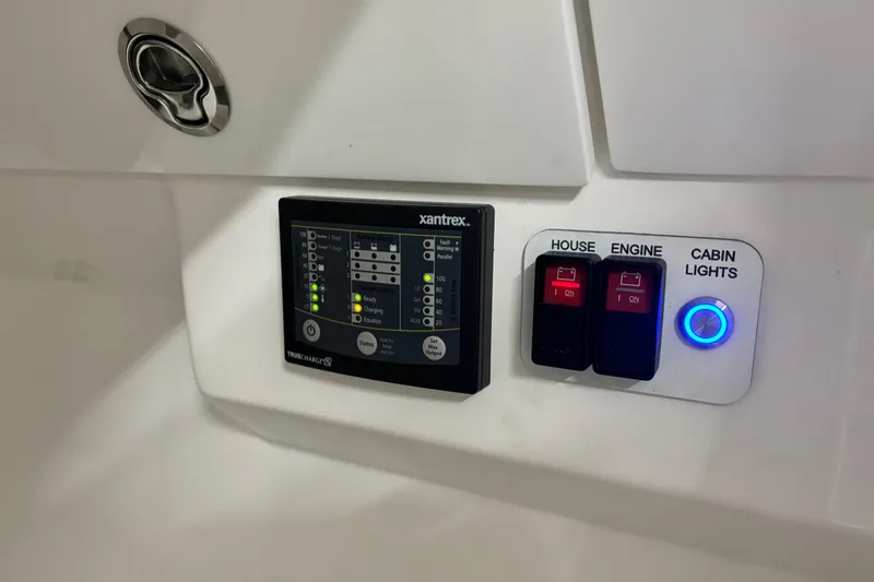 Slide: The Image of Control panel of 2023 Everglades 285 Center Console boat with switches and indicators. - 25