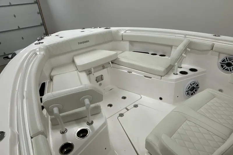 Slide: The Image of 2023 Everglades 285 Center Console boat interior with white seating and cup holders. - 28