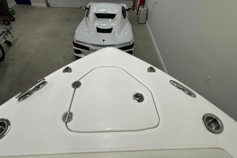Slide: The Image of 2023 Everglades 285 Center Console boat in garage with sports car. - 32