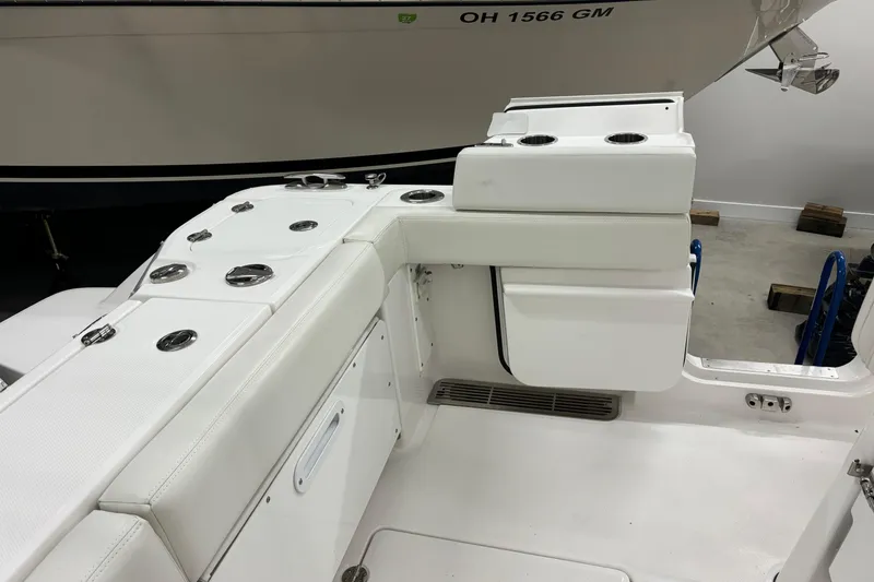 Slide: The Image of 2023 Everglades 285 Center Console boat interior with white seating and cup holders. - 9