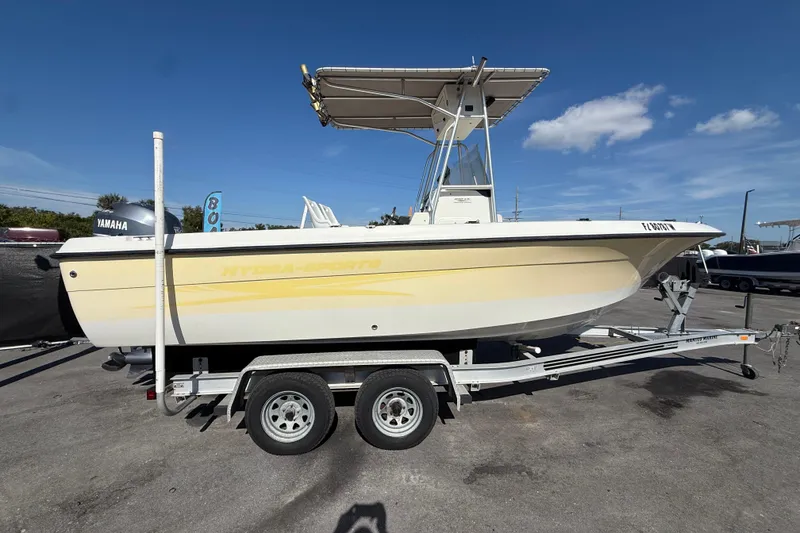 Slide: The Image of 2006 Hydra-Sports Lightning 212 CC boat on trailer, side view, clear sky background. - 1