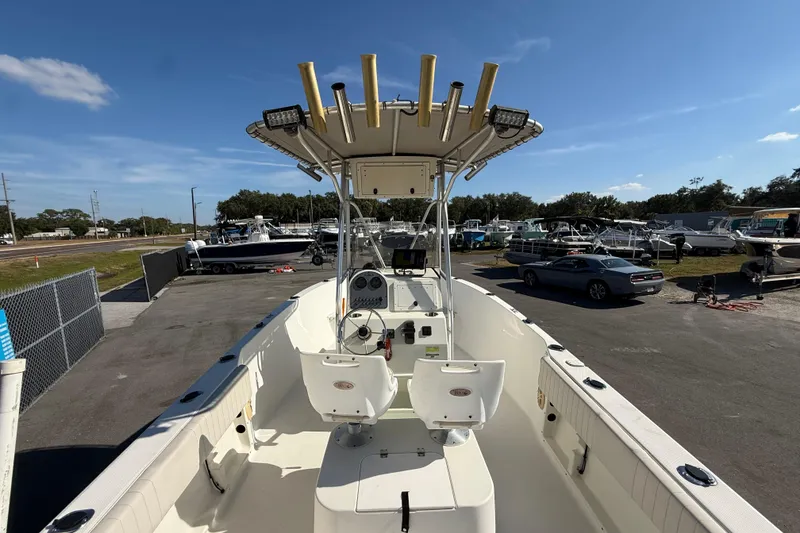 Slide: The Image of 2006 Hydra-Sports Lightning 212 CC boat with T-top, parked in a marina under clear skies. - 15