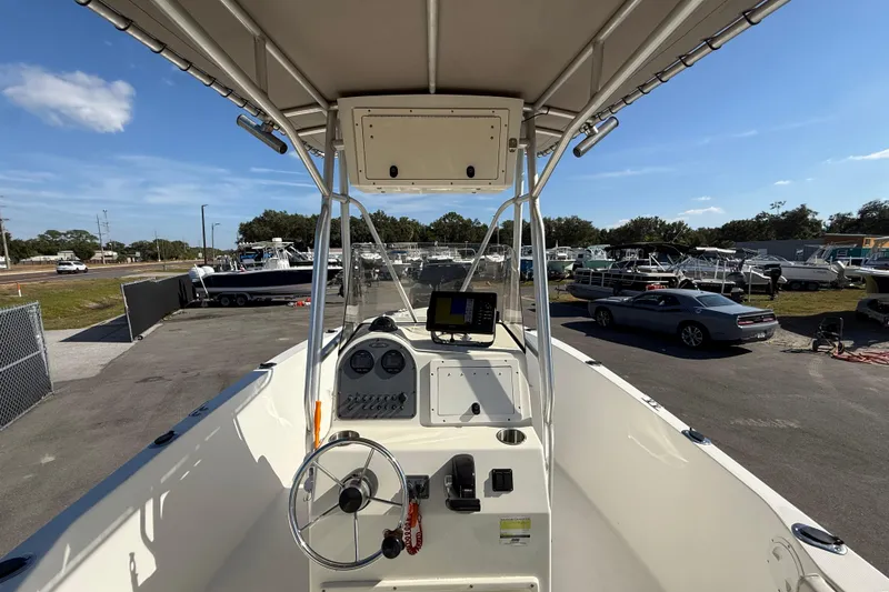 Slide: The Image of 2006 Hydra-Sports Lightning 212 CC boat dashboard with steering wheel and navigation equipment. - 23