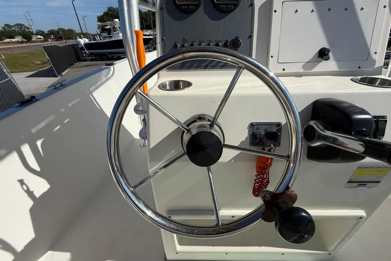 Slide: The Image of Steering wheel of a 2006 Hydra-Sports Lightning 212 CC boat, featuring control panel. - 26