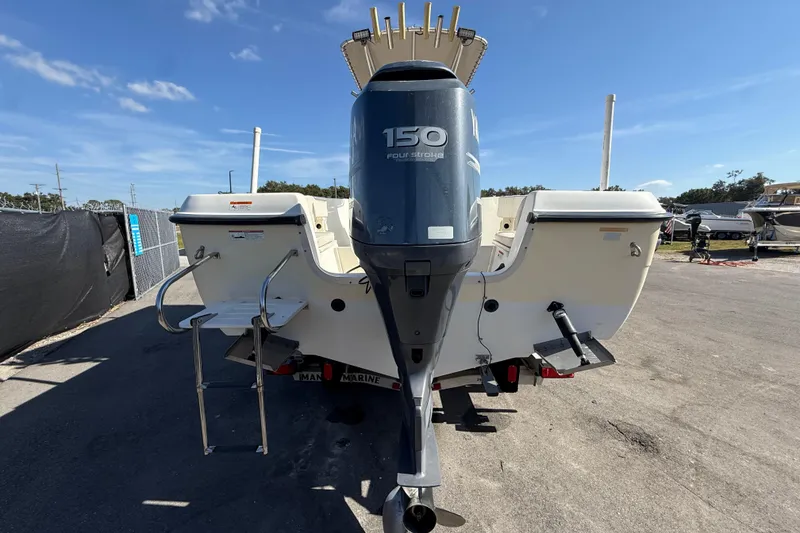 Slide: The Image of 2006 Hydra-Sports Lightning 212 CC boat with 150 horsepower outboard motor, parked outdoors. - 4