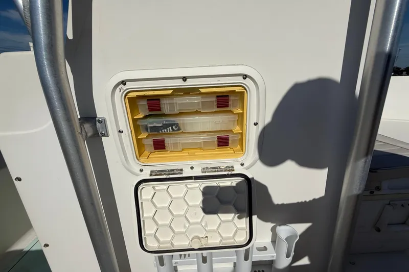 Slide: The Image of 2006 Hydra-Sports Lightning 212 CC boat storage compartment with tackle boxes. - 41