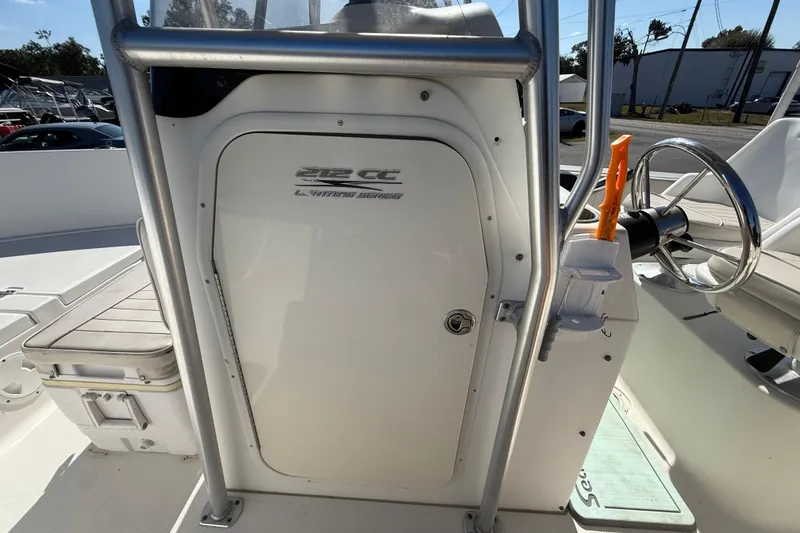 Slide: The Image of 2006 Hydra-Sports Lightning 212 CC boat console with steering wheel and storage compartment. - 42