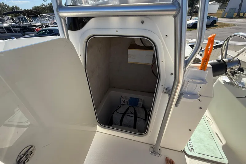 Slide: The Image of 2006 Hydra-Sports Lightning 212 CC boat storage compartment with open door and visible interior. - 43
