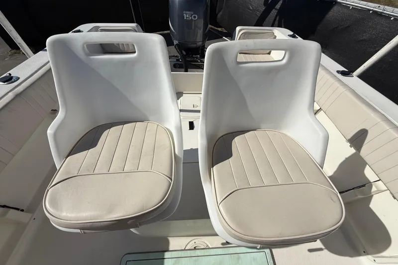 Slide: The Image of 2006 Hydra-Sports Lightning 212 CC boat interior with two white cushioned seats. - 65