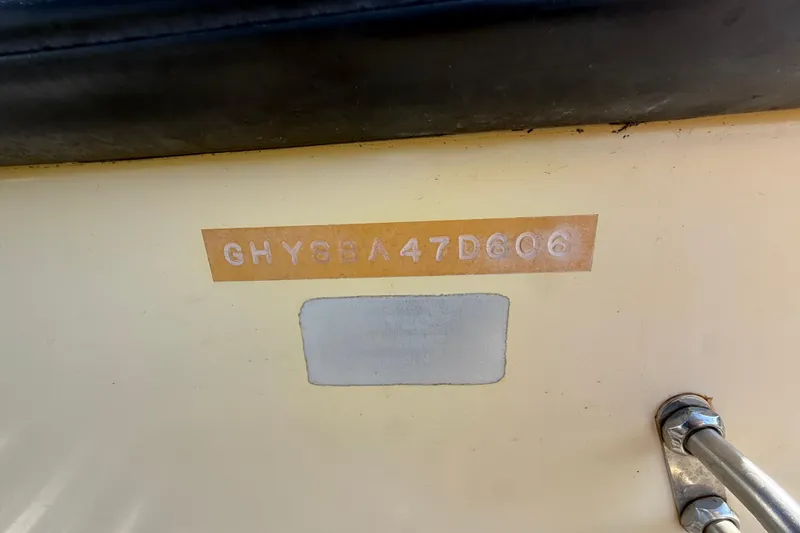 Slide: The Image of 2006 Hydra-Sports Lightning 212 CC hull identification number on beige surface. - 76
