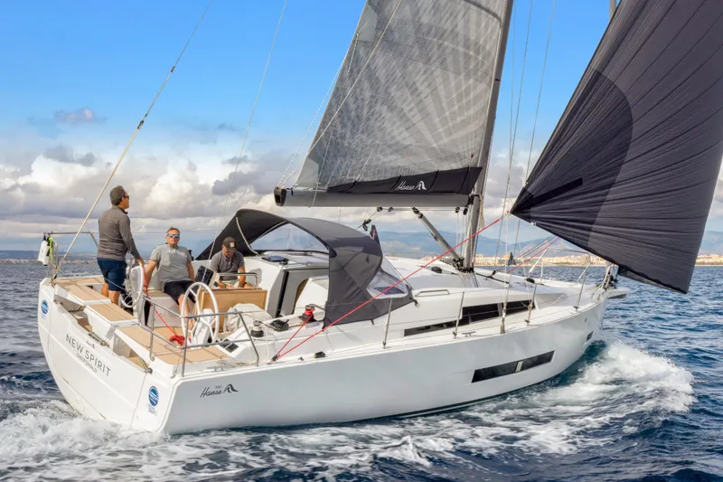 Slide: The Image of Sailing on a 2026 Hanse 360 yacht with three people onboard, under clear skies. - 12