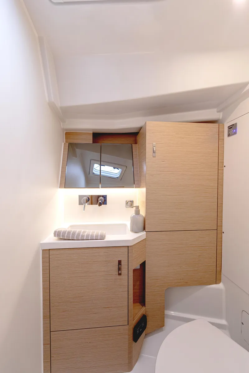Slide: The Image of Modern bathroom interior of 2025 Hanse 360 #41 yacht, featuring sleek wooden cabinetry. - 31