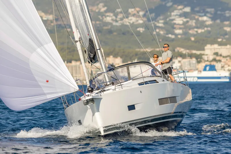 Slide: The Image of 2026 Hanse 360 sailboat navigating ocean waters with two people onboard. - 6